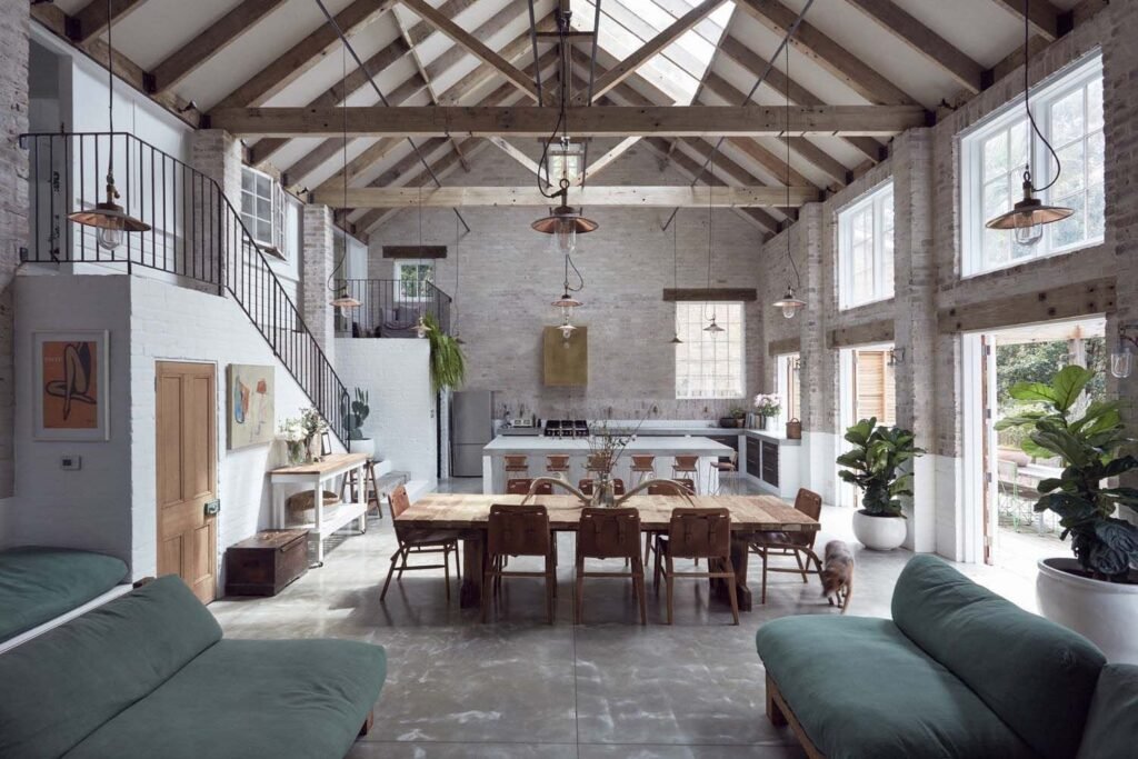 Large living room with an exposed ceiling offering a warm industrial farmhouse feel.